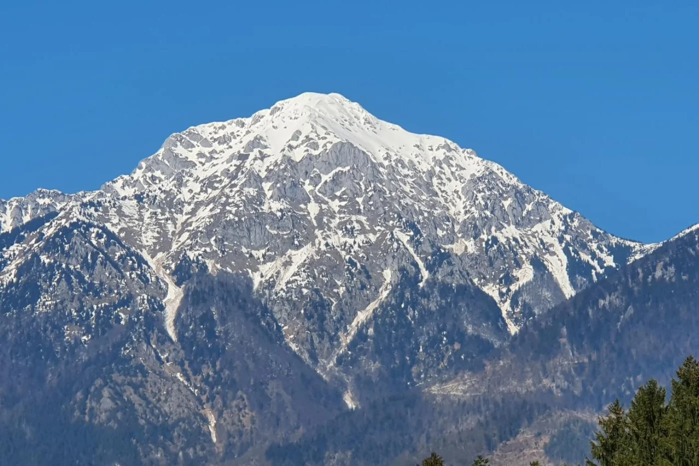Snowy Storžič summit with its distinctive pyramid shape, Slovenia